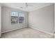 Neutral bedroom featuring carpeted floor, a double window, and soft grey walls at 1001 Woodglen Ln, Matthews, NC 28104
