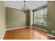An empty dining room featuring hardwood floors and a hanging light fixture at 1001 Woodglen Ln, Matthews, NC 28104