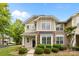 Charming two-story home featuring stone accents and manicured landscaping at 1001 Woodglen Ln, Matthews, NC 28104