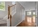 Hallway featuring beautiful hardwood floors and staircase at 1001 Woodglen Ln, Matthews, NC 28104