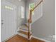 Bright foyer showcasing hardwood floors and a staircase with wood railing at 1001 Woodglen Ln, Matthews, NC 28104