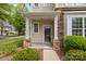 Inviting front porch with stone accents and meticulously maintained landscape at 1001 Woodglen Ln, Matthews, NC 28104