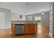 Kitchen island bar with stainless dishwasher and hardwood floors at 1001 Woodglen Ln, Matthews, NC 28104