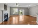 Open living room featuring hardwood floors, a fireplace, and natural light at 1001 Woodglen Ln, Matthews, NC 28104