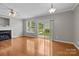 Sunlit living room with fireplace, window, and sliding door at 1001 Woodglen Ln, Matthews, NC 28104