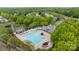 Overhead view of a community pool area surrounded by greenery, lounge chairs and seating at 1001 Woodglen Ln, Matthews, NC 28104