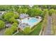 Aerial view of a community pool with large swimming area, seating, and manicured landscaping at 1001 Woodglen Ln, Matthews, NC 28104