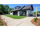 An outdoor entertaining area with stone and siding features, covered patio and lounge seating at 1003 Idyllic Ln, Waxhaw, NC 28173