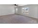 Spacious bedroom with wall-to-wall carpet and natural light from the multiple windows at 1041 Secor St, Statesville, NC 28677