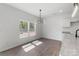 Dining area with a light fixture, view to a window, and access to the kitchen at 1041 Secor St, Statesville, NC 28677