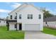Charming two-story home with white siding, attached garage, and well-maintained lawn at 1041 Secor St, Statesville, NC 28677