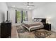 Bright bedroom featuring a decorative rug, ceiling fan and natural light from two windows at 1045 Cavalier Ln, Rock Hill, SC 29730