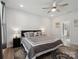 Primary bedroom features a ceiling fan, decorative rug, and adjacent primary bathroom at 1045 Cavalier Ln, Rock Hill, SC 29730