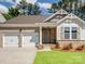 Charming brick home featuring a two-car garage and a well-manicured lawn at 1045 Cavalier Ln, Rock Hill, SC 29730