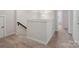 Second floor hallway featuring neutral walls and carpet with a small banister and light fixture at 1045 Cavalier Ln, Rock Hill, SC 29730