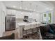 Bright, modern kitchen features white cabinets, stainless steel appliances, and a breakfast bar with seating at 1045 Cavalier Ln, Rock Hill, SC 29730