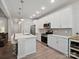 The bright kitchen features white cabinets, stainless steel appliances and a central island with bar seating at 1045 Cavalier Ln, Rock Hill, SC 29730