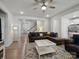 Open-concept living room featuring laminate floors, a ceiling fan, and a view of the staircase at 1045 Cavalier Ln, Rock Hill, SC 29730