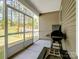 Screened-in porch with grill and firepit and view of the backyard with play set at 1045 Cavalier Ln, Rock Hill, SC 29730