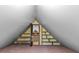 Partially furnished attic with shelving and an open doorway leading to the stairs at 1074 Oakridge Farm Hwy, Mooresville, NC 28115
