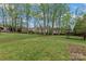 Expansive backyard with lush lawn and mature trees, perfect for outdoor activities at 1074 Oakridge Farm Hwy, Mooresville, NC 28115