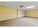 Basement featuring laminate flooring, built-in shelving, and ample natural light at 1074 Oakridge Farm Hwy, Mooresville, NC 28115