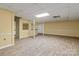 Spacious finished basement with light flooring and bar-style kitchen area at 1074 Oakridge Farm Hwy, Mooresville, NC 28115