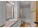 Cozy bathroom featuring a single sink, tiled shower, and decorative mirror at 1074 Oakridge Farm Hwy, Mooresville, NC 28115