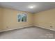 Bedroom features a window with views of the greenery outside at 1074 Oakridge Farm Hwy, Mooresville, NC 28115