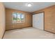 Bedroom featuring a view of a red-flowered tree and a large closet at 1074 Oakridge Farm Hwy, Mooresville, NC 28115