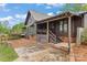 Charming two-story home with a metal roof, covered porch, and a deck overlooking a well maintained yard at 1074 Oakridge Farm Hwy, Mooresville, NC 28115