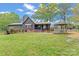 Charming home with a covered porch, metal roof, a gazebo and swing in the well maintained expansive backyard at 1074 Oakridge Farm Hwy, Mooresville, NC 28115