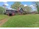 Charming home with a covered porch and gazebo overlooking a sprawling backyard, perfect for outdoor entertaining at 1074 Oakridge Farm Hwy, Mooresville, NC 28115