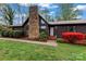 Close-up of single-story home's front entrance with stone chimney and manicured lawn at 1074 Oakridge Farm Hwy, Mooresville, NC 28115