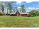 Charming single-story home featuring a stone chimney and well-maintained landscaping at 1074 Oakridge Farm Hwy, Mooresville, NC 28115