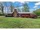 Charming single-story home featuring a stone chimney and well-maintained landscaping at 1074 Oakridge Farm Hwy, Mooresville, NC 28115