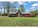 Charming single-story home featuring a stone chimney and well-maintained landscaping at 1074 Oakridge Farm Hwy, Mooresville, NC 28115