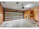 Spacious two car garage with paneled walls, side entry door and automatic door opening system at 1074 Oakridge Farm Hwy, Mooresville, NC 28115