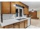 Kitchen sink with bright light coming from the window and access to a Gathering room with a fireplace at 1074 Oakridge Farm Hwy, Mooresville, NC 28115