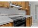 Close-up of the kitchen featuring a clean cooktop and oven with overhead exhaust fan at 1074 Oakridge Farm Hwy, Mooresville, NC 28115