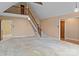 Open-concept living area with staircase leading to loft and view of kitchen at 1074 Oakridge Farm Hwy, Mooresville, NC 28115