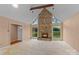 Spacious living room featuring a stone fireplace and large windows with natural light at 1074 Oakridge Farm Hwy, Mooresville, NC 28115