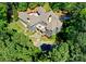 An aerial view shows the house, expansive grounds, pool, and patio at 10915 Hermit Thrush Ln, Charlotte, NC 28278