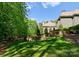 A manicured lawn and retaining wall define this sloped backyard at 10915 Hermit Thrush Ln, Charlotte, NC 28278