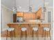 Stylish bar area with wood cabinetry, granite countertops, and modern pendant lighting at 10915 Hermit Thrush Ln, Charlotte, NC 28278