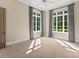 Bright bedroom with large windows offering plenty of natural light and neutral carpet flooring at 10915 Hermit Thrush Ln, Charlotte, NC 28278