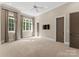 Spacious bedroom with large windows, neutral color palette, and walk-in closet at 10915 Hermit Thrush Ln, Charlotte, NC 28278