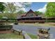A charming, lodge-style clubhouse features an open porch and inviting landscaping at 10915 Hermit Thrush Ln, Charlotte, NC 28278