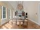 Dining room area with fireplace, hardwood floors, and natural light at 10915 Hermit Thrush Ln, Charlotte, NC 28278