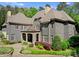 Stunning home exterior featuring manicured landscaping, stone accents, and private balcony at 10915 Hermit Thrush Ln, Charlotte, NC 28278